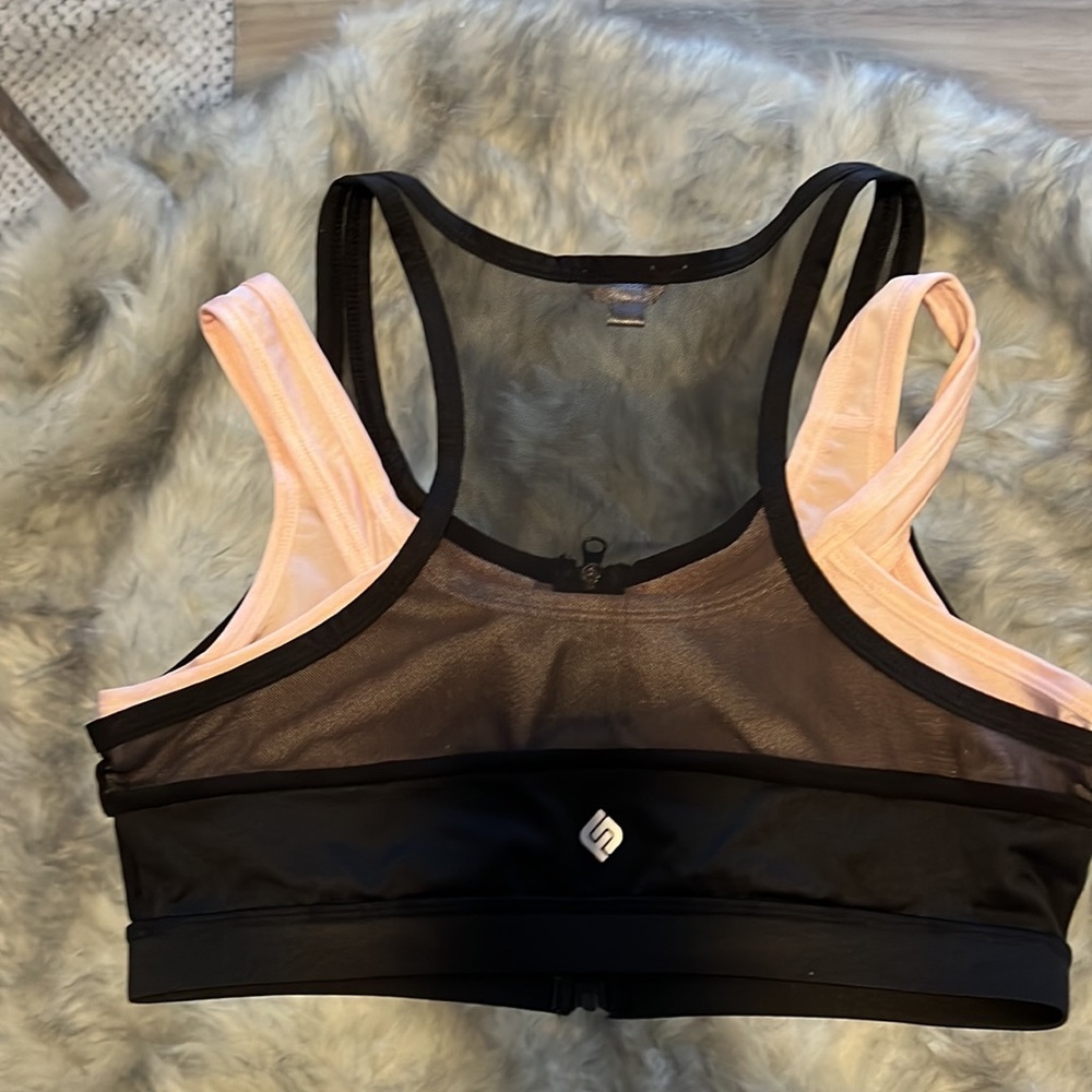 Pink and black mesh front zip sports bra
